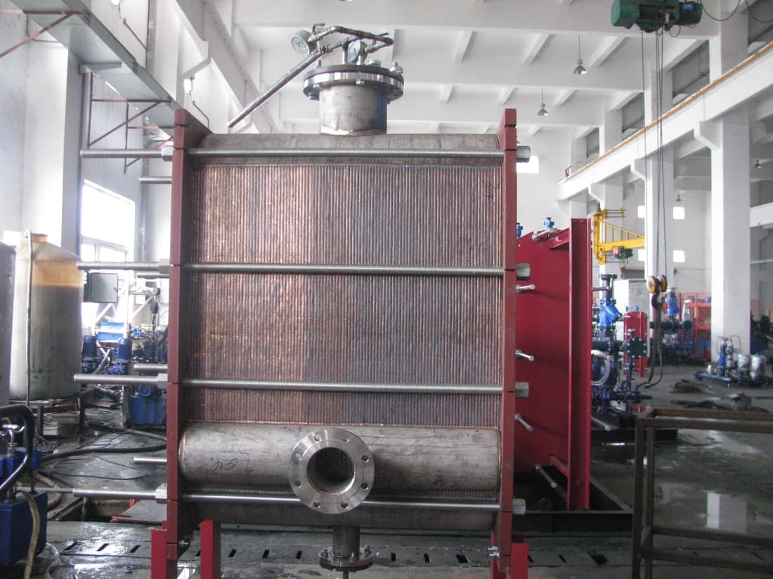 A fully welded plate pack in its frame, built for a condensing duty. No gasket anywhere in the thermal section, so temperature stops being the limit.