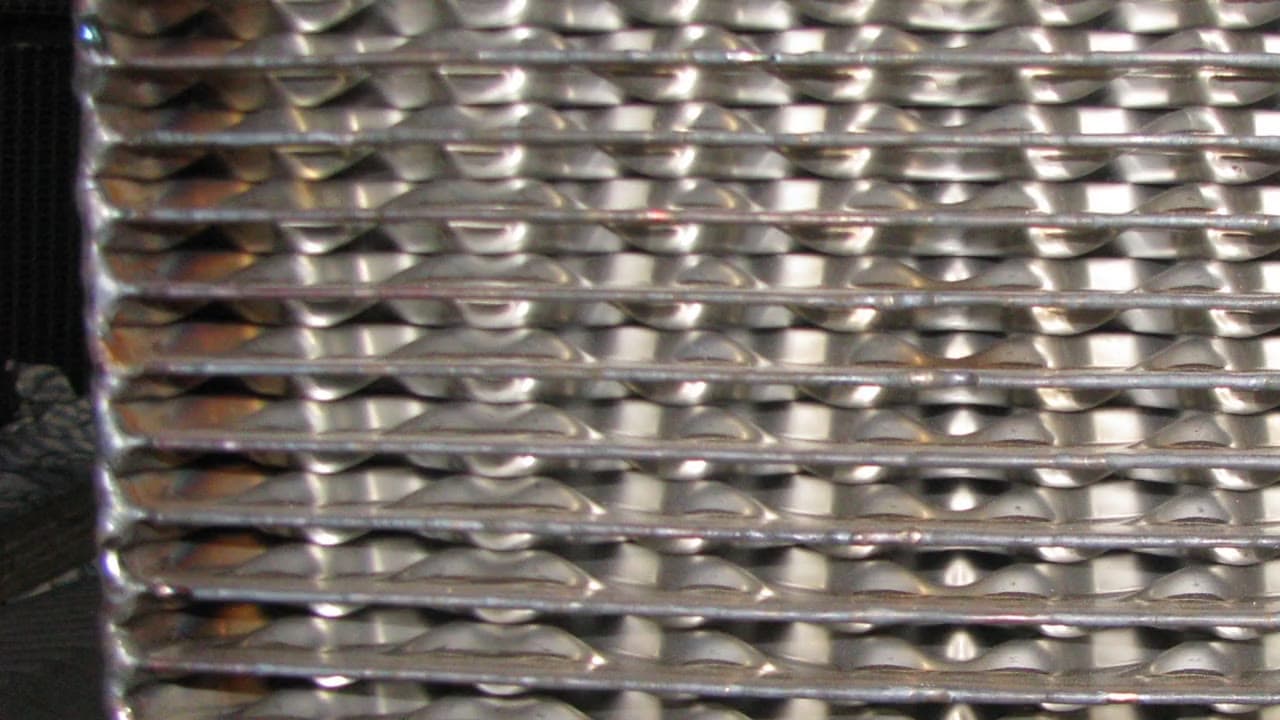 Close view of a welded plate pack showing the seam-welded channel edges