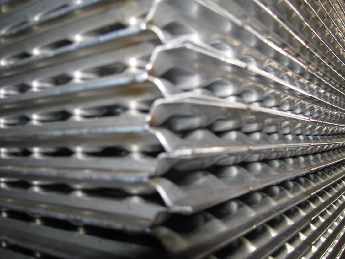 Plates stacked during welding: each pair sealed to the next, which is what removes the gasket from the pack.
